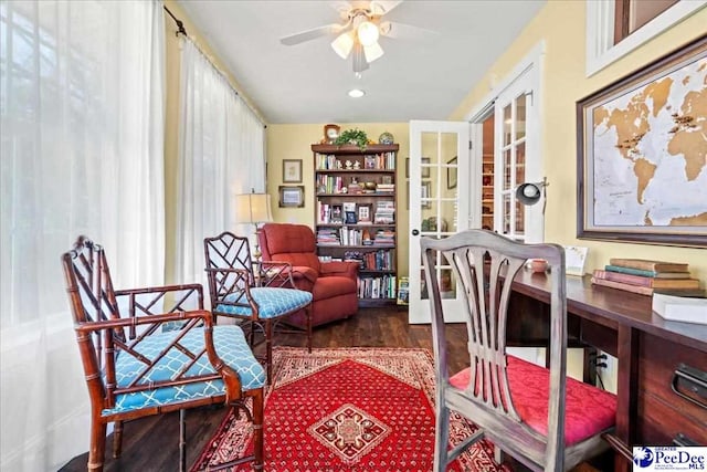 living area with dark wood finished floors and a ceiling fan