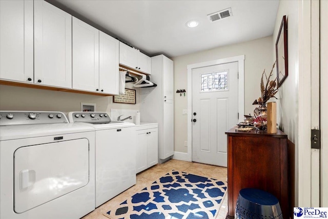 laundry area featuring cabinet space, baseboards, visible vents, independent washer and dryer, and light tile patterned flooring