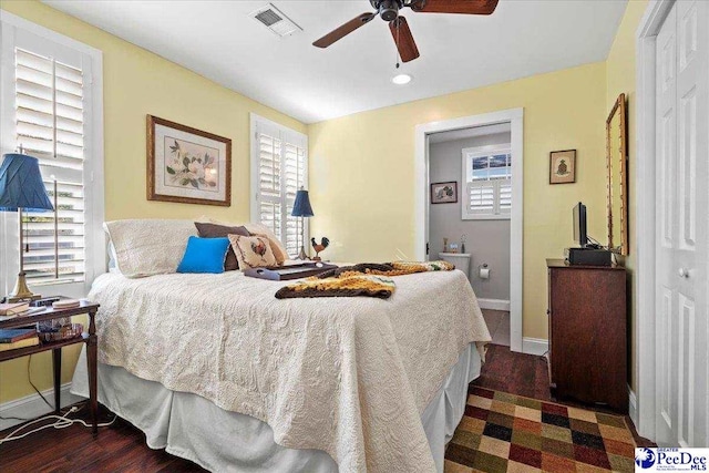 bedroom featuring dark wood-style floors, baseboards, visible vents, and a ceiling fan