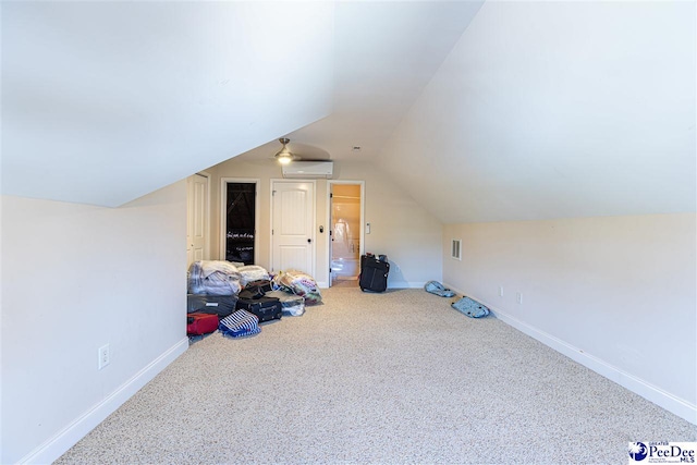 additional living space featuring lofted ceiling, carpet floors, and a wall mounted AC