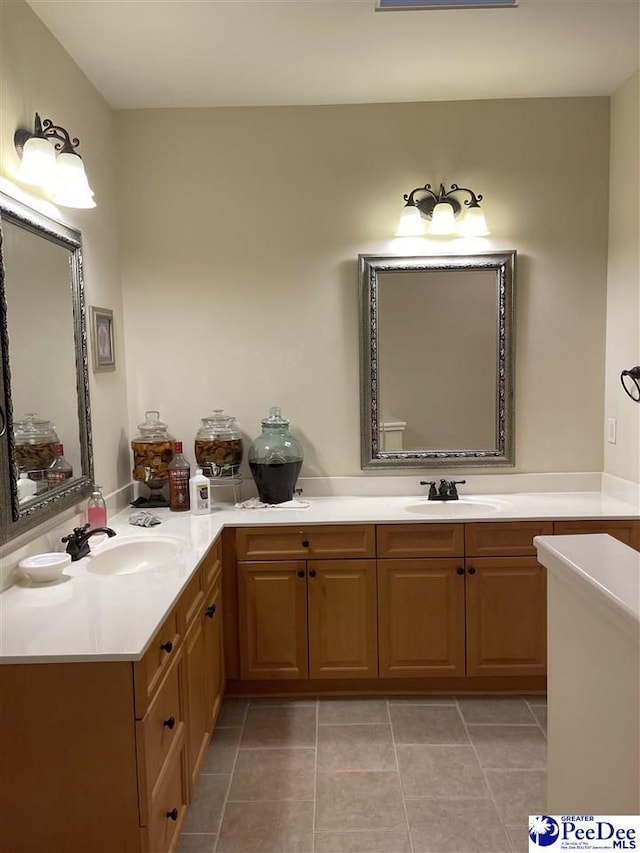 bathroom with tile patterned floors and vanity