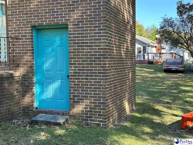 property entrance with a yard