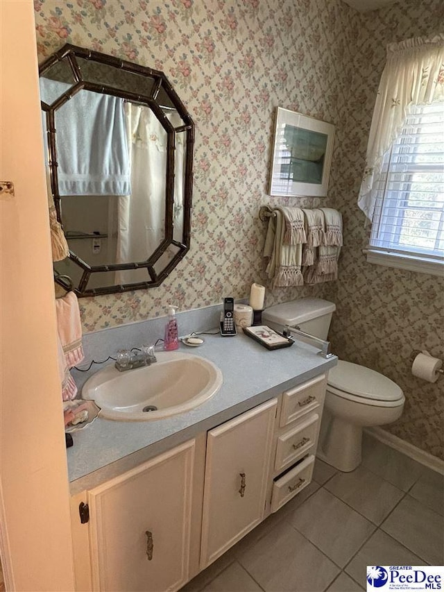 bathroom featuring vanity, tile patterned floors, and toilet