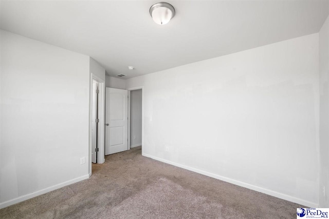 unfurnished bedroom with carpet floors and baseboards