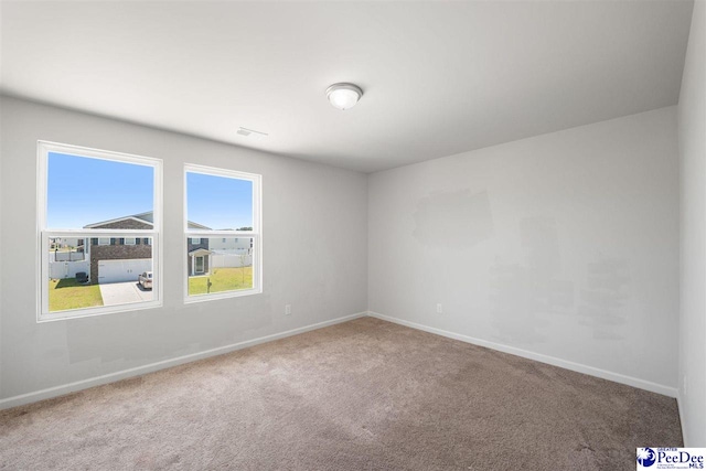 spare room with carpet floors and baseboards