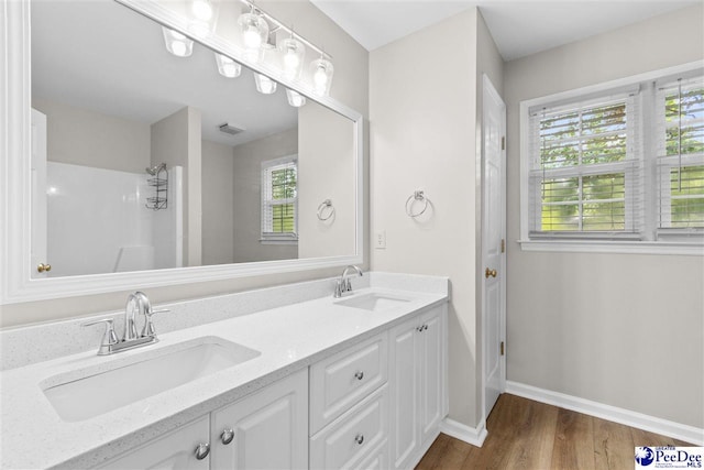 2348 Chadwick Dr, Florence, SC 29501 - full bathroom with wood finished floors, double vanity, and a shower