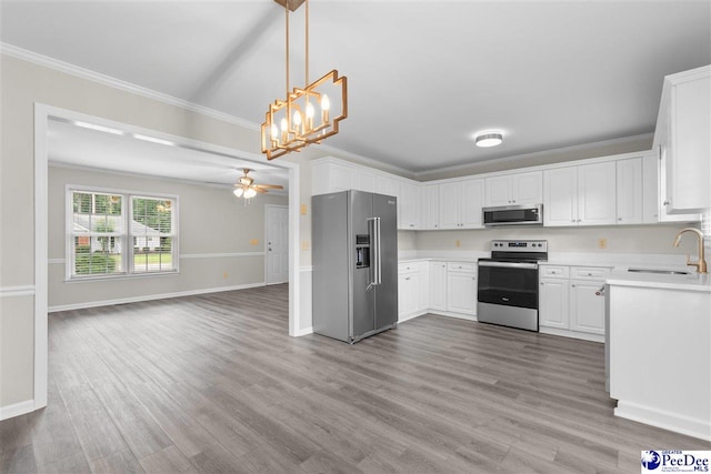 2348 Chadwick Dr, Florence, SC 29501 - kitchen with appliances with stainless steel finishes, wood finished floors, light countertops, ornamental molding, and open floor plan