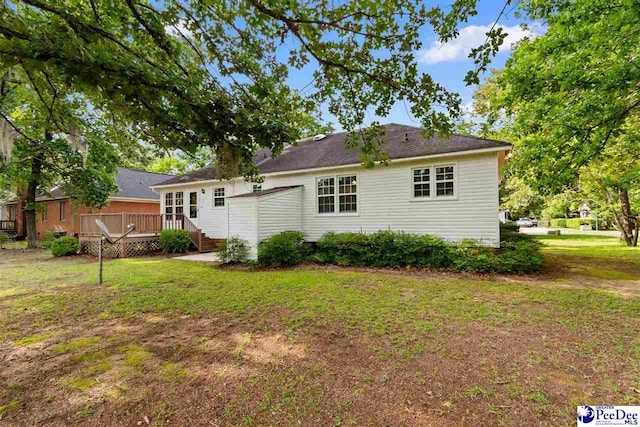2348 Chadwick Dr, Florence, SC 29501 - rear view of house with a wooden deck and a lawn