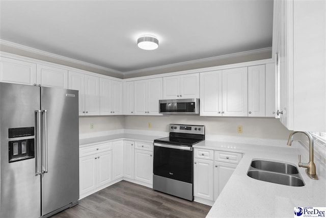2348 Chadwick Dr, Florence, SC 29501 - kitchen with stainless steel appliances, white cabinets, ornamental molding, and dark wood finished floors