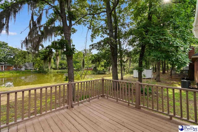 2348 Chadwick Dr, Florence, SC 29501 - deck with a water view, a shed, and view of wooded area