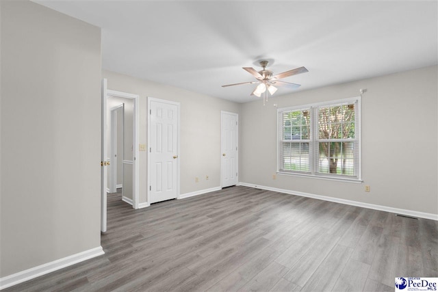 2348 Chadwick Dr, Florence, SC 29501 - unfurnished bedroom featuring wood finished floors and a ceiling fan