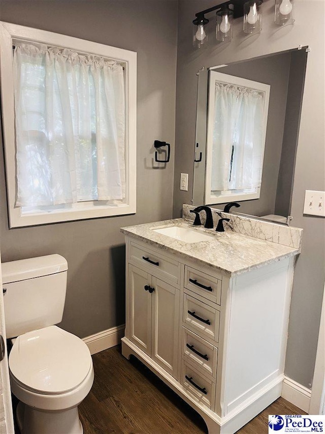 506 W College Ave, Hartsville, SC 29550 - half bathroom featuring baseboards, wood finished floors, toilet, and vanity