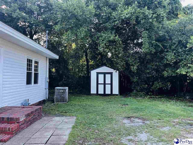 506 W College Ave, Hartsville, SC 29550 - view of grassy yard with cooling unit, a storage shed, and an outdoor structure