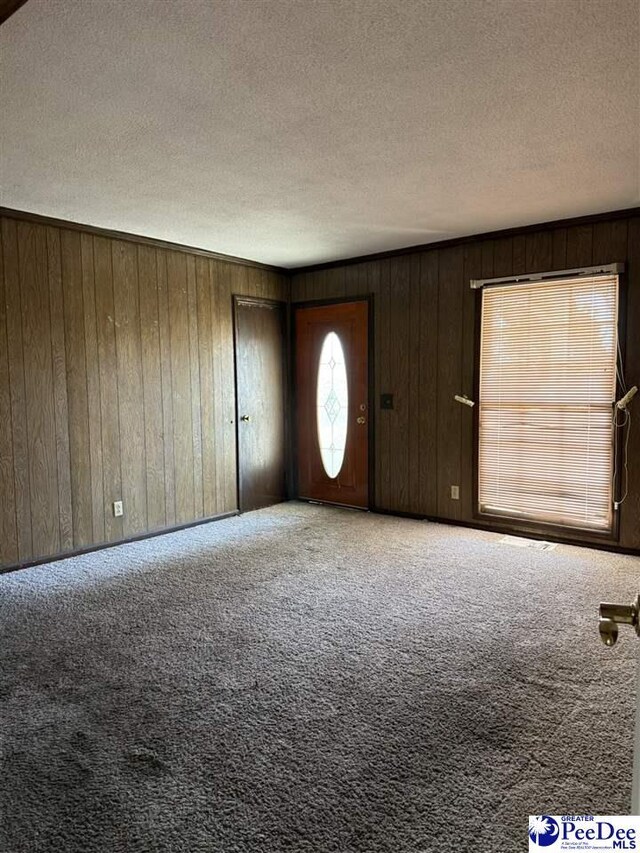 885 Enoch Ct, Mullins, SC 29574 - carpeted foyer with wood walls and a textured ceiling