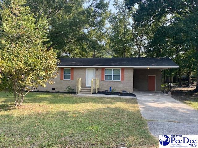 ranch-style house with a carport and a front yard