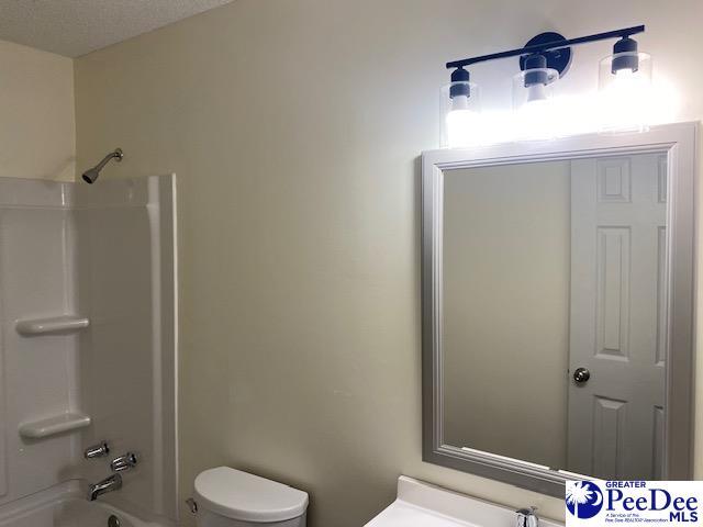 full bathroom with vanity,  shower combination, and toilet