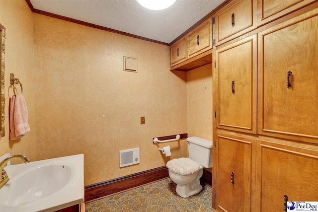 bathroom featuring crown molding, vanity, and toilet