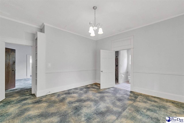 unfurnished room with dark colored carpet, a chandelier, and crown molding