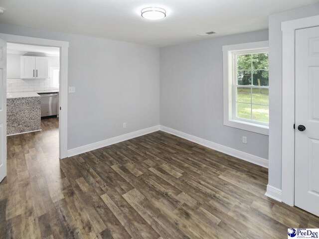 906 Gladstone St, Florence, SC 29501 - empty room featuring baseboards and dark wood-type flooring