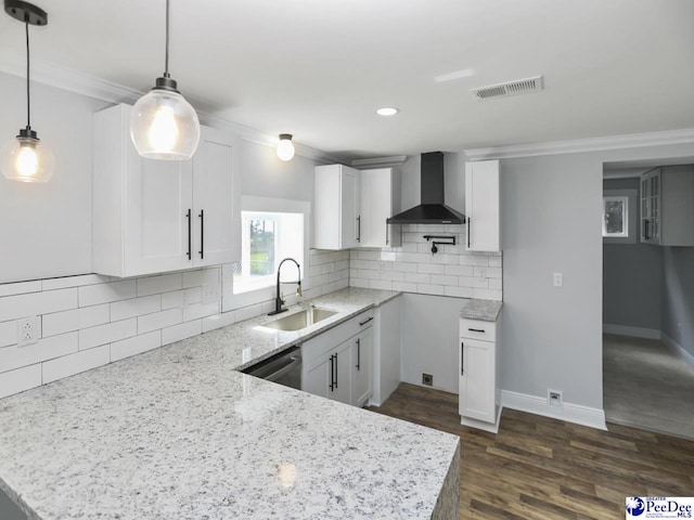 906 Gladstone St, Florence, SC 29501 - kitchen with wall chimney range hood, a sink, crown molding, light stone counters, and a peninsula
