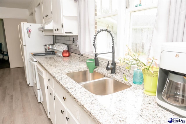 kitchen with sink, white cabinets, decorative backsplash, white electric range oven, and light stone countertops