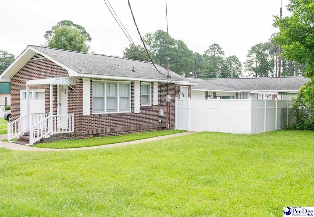 ranch-style home with a front lawn