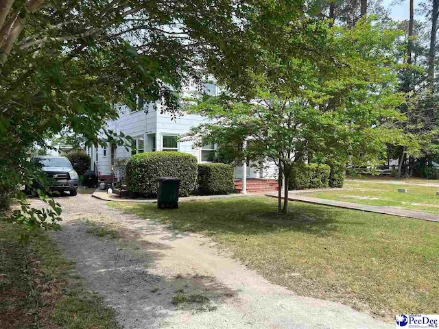 309 E Proctor St, Mullins, SC 29574 - view of front of house featuring a front lawn