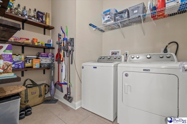 3471 Sweetgrass Dr, Florence, SC 29501 - laundry area featuring washing machine and dryer, light tile patterned floors, and baseboards