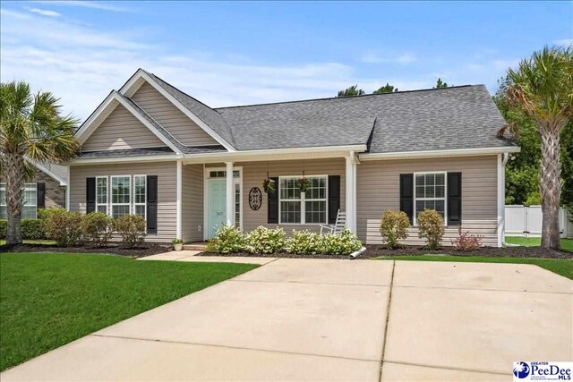 3471 Sweetgrass Dr, Florence, SC 29501 - view of front of property featuring a front yard and a shingled roof