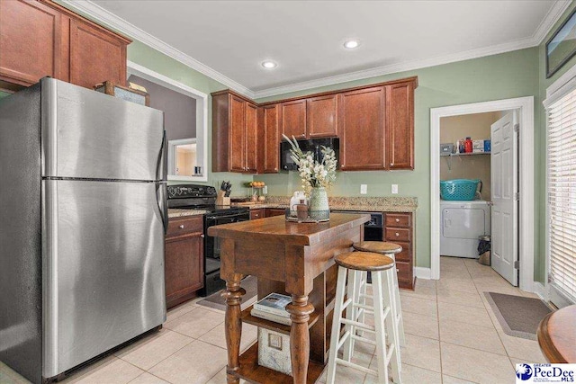 3471 Sweetgrass Dr, Florence, SC 29501 - kitchen featuring black appliances, light tile patterned flooring, washer / clothes dryer, crown molding, and recessed lighting