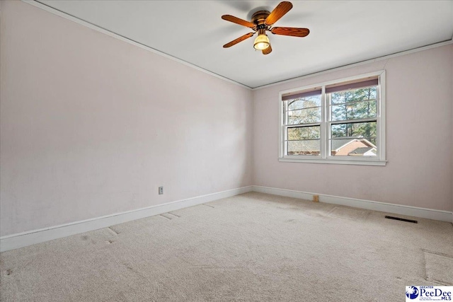 unfurnished room featuring a ceiling fan, carpet, visible vents, and baseboards