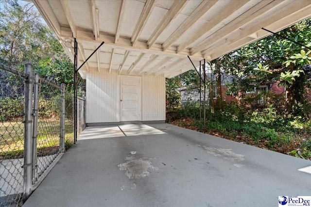 garage featuring a carport and a gate