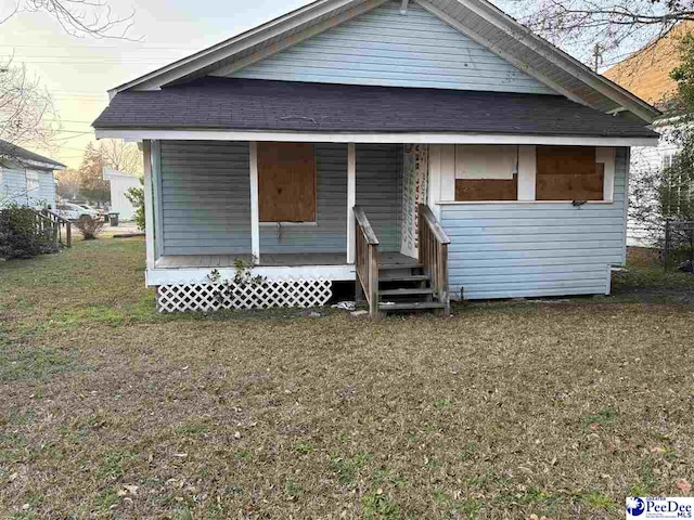 bungalow with a porch and a front yard