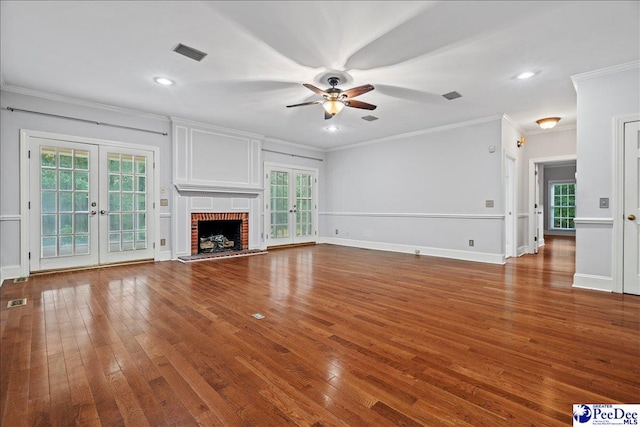 unfurnished living room featuring hardwood / wood-style flooring, a fireplace, and french doors