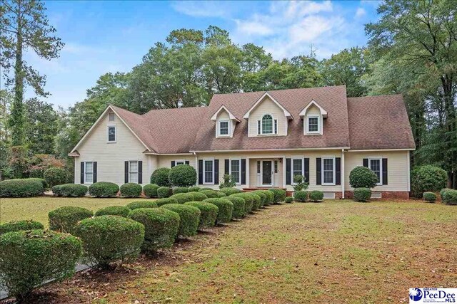 cape cod-style house with a front yard