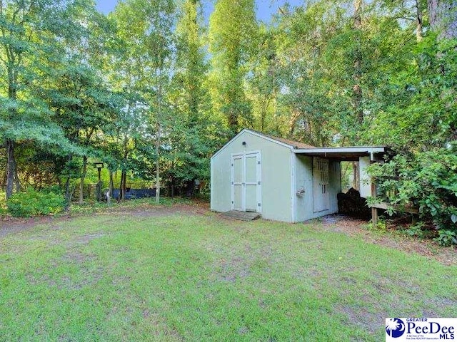 1417 Woods Rd, Florence, SC 29501 - view of grassy yard with a storage unit