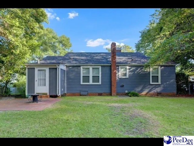 1417 Woods Rd, Florence, SC 29501 - back of property with a patio area, a chimney, and a shingled roof