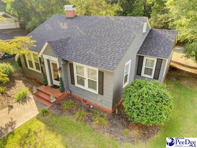 1417 Woods Rd, Florence, SC 29501 - bungalow featuring roof with shingles and a chimney