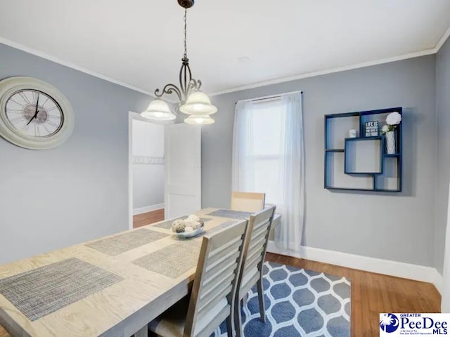 1417 Woods Rd, Florence, SC 29501 - dining area featuring crown molding, wood finished floors, and a chandelier