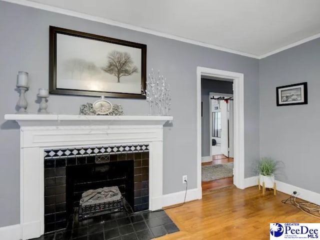 1417 Woods Rd, Florence, SC 29501 - living room with a tile fireplace, crown molding, and wood finished floors