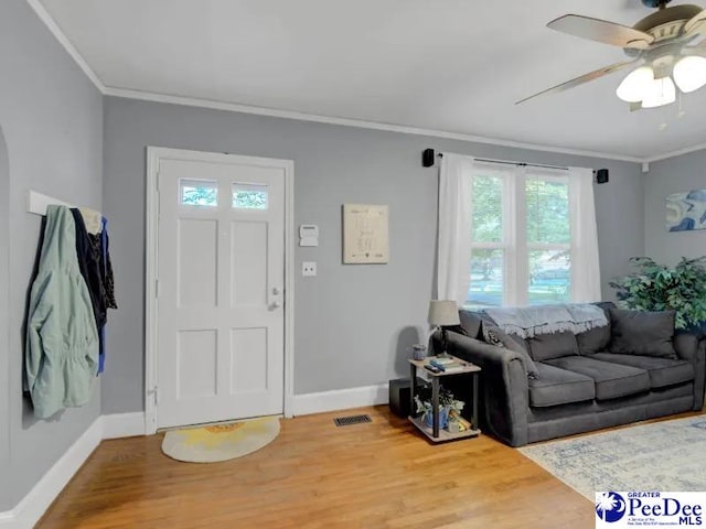 1417 Woods Rd, Florence, SC 29501 - foyer with crown molding, plenty of natural light, wood finished floors, and a ceiling fan