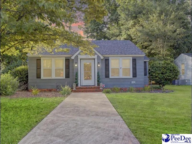 1417 Woods Rd, Florence, SC 29501 - view of front of home with a front yard and roof with shingles