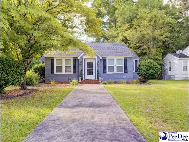 1417 Woods Rd, Florence, SC 29501 - bungalow-style house featuring a front lawn and roof with shingles