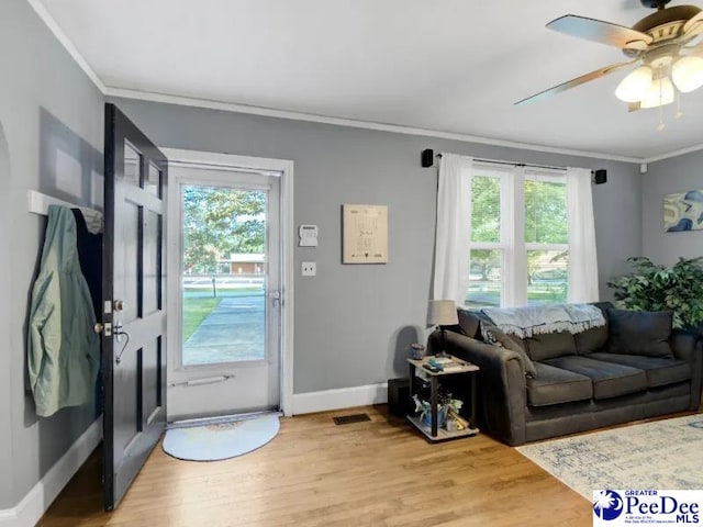 1417 Woods Rd, Florence, SC 29501 - entryway with crown molding, light wood-style floors, and ceiling fan