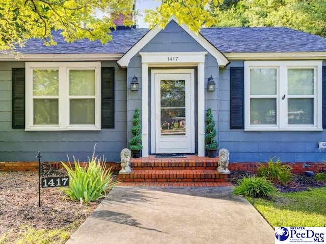 1417 Woods Rd, Florence, SC 29501 - view of exterior entry with roof with shingles