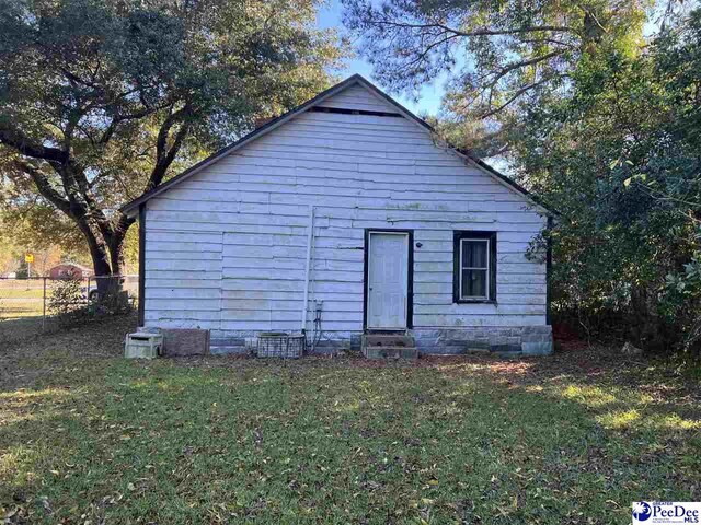 view of outbuilding featuring a yard