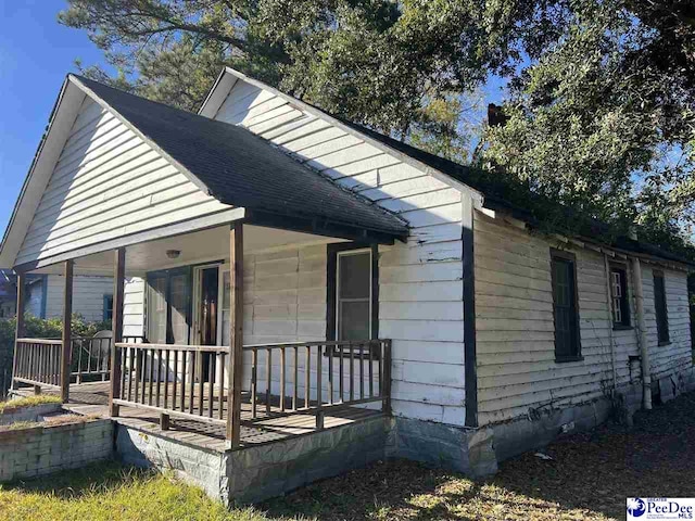 view of property exterior with a porch