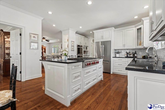 kitchen with recessed lighting, white cabinets, tasteful backsplash, and stainless steel appliances