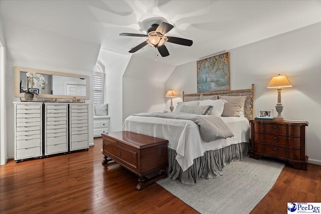 bedroom with ceiling fan, vaulted ceiling, and wood finished floors