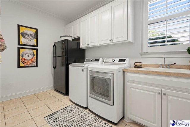 washroom featuring a sink, independent washer and dryer, light tile patterned floors, and ornamental molding